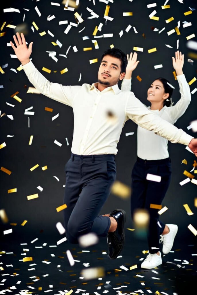 A person freezing mid-air while someone else dances around them with confetti.